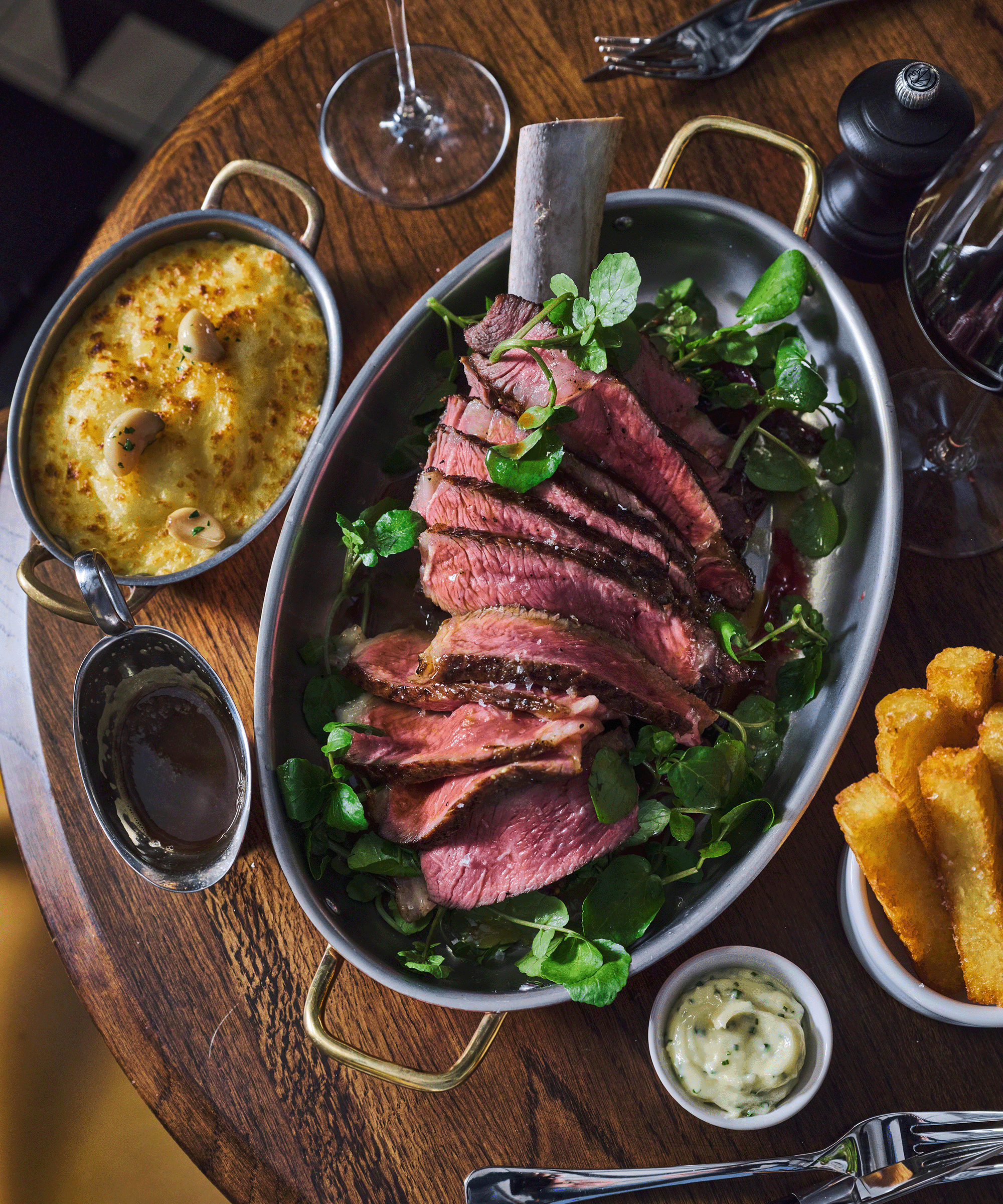 Tomahawk Steak with side dishes on a wooden table